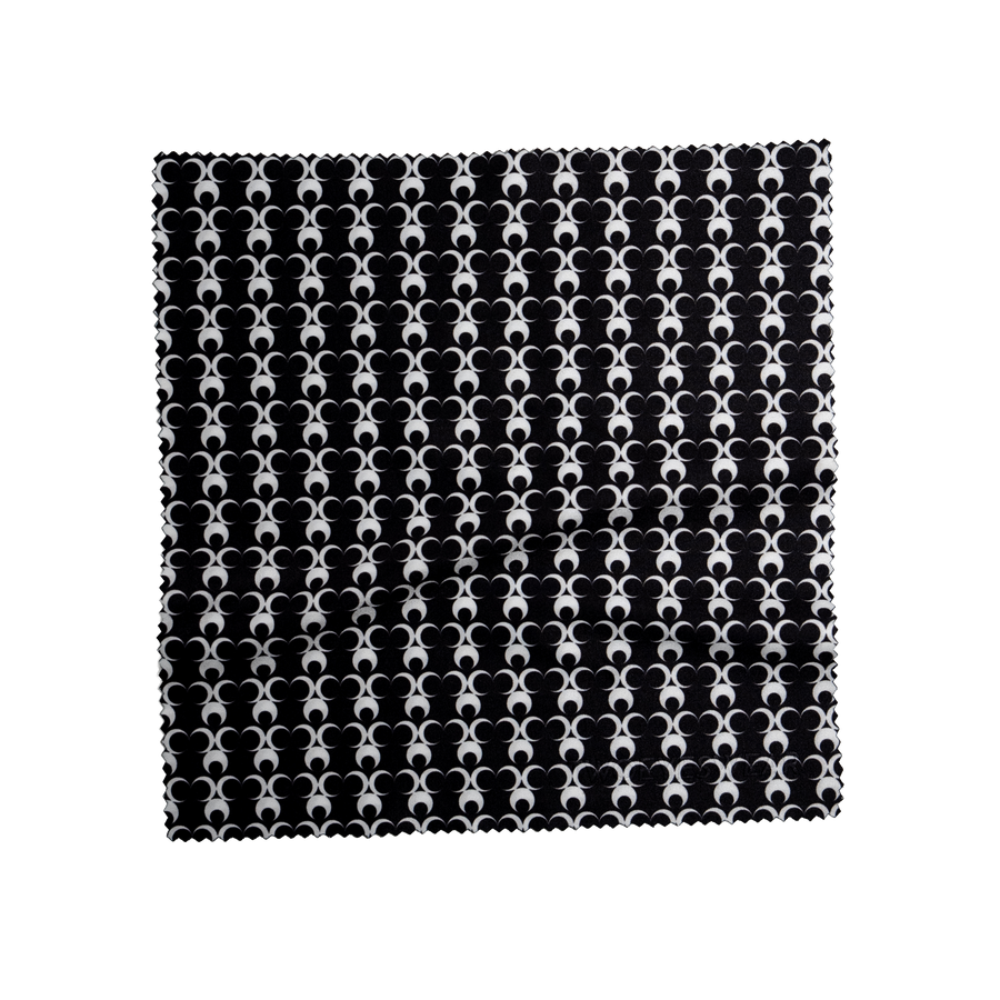 Noir Eclipse microfiber lens cloth laid flat, repeating white half moon print on Noir Black