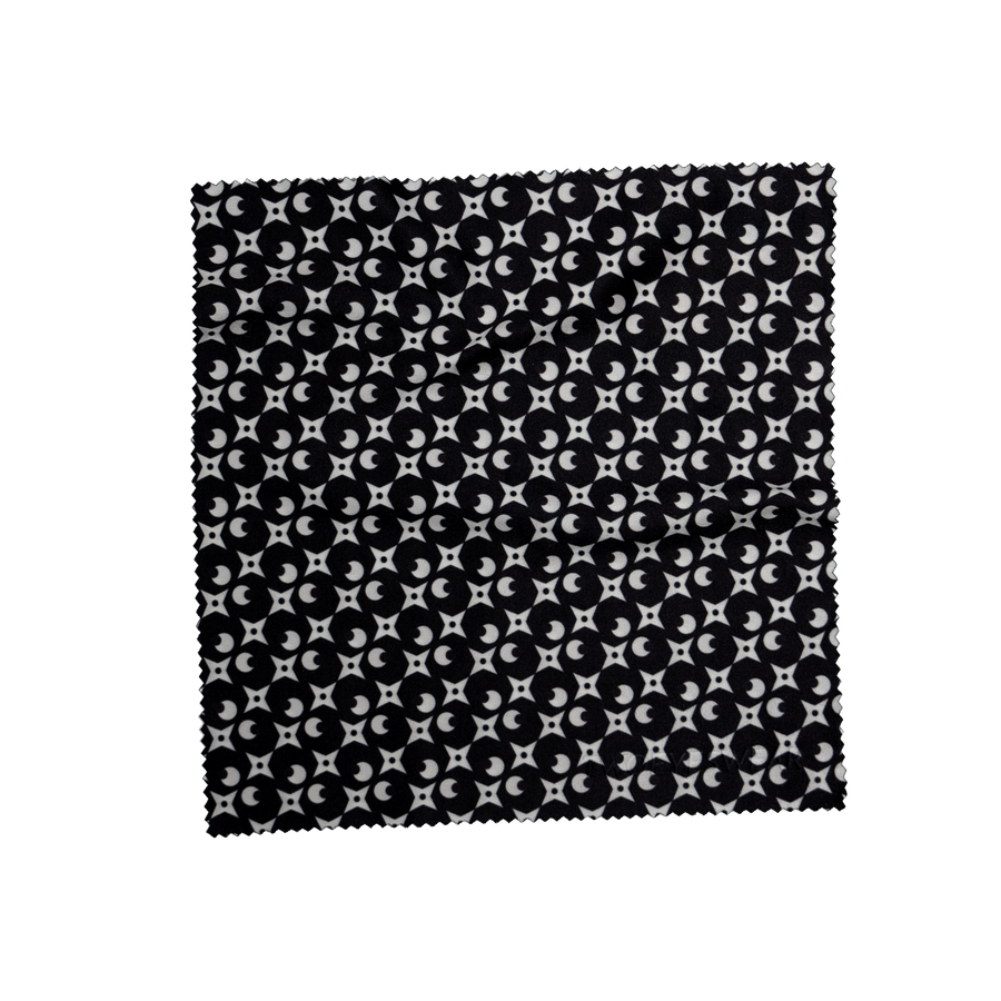 Noir Luna microfiber lens cloth laid flat, white crescent moon and sparkle print on Noir Black