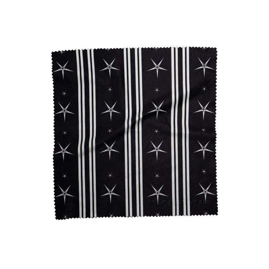 Noir Comet microfiber lens cloth laid flat, white stripes and stars on Noir Black